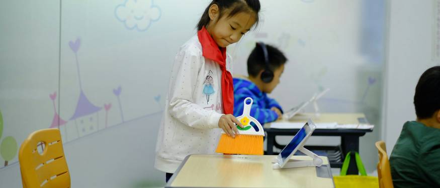 Teacher using cognitive skill tracking tools with children in a classroom setting